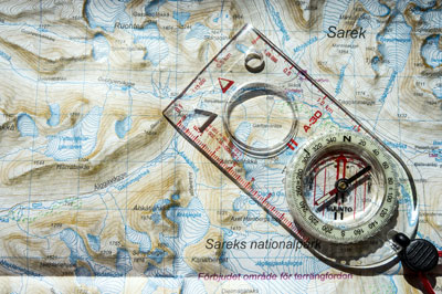 Compass laid over a map.