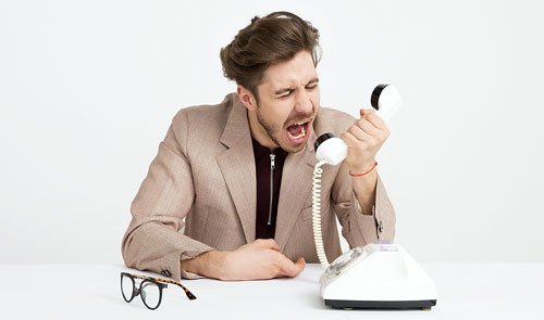Person dealing with an annoying phone call.