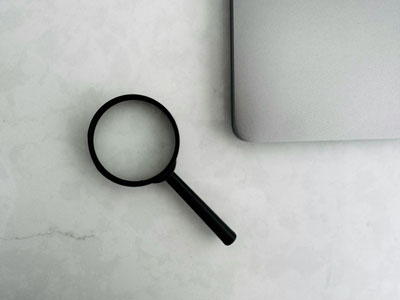Magnifying glass over a pale map.