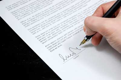 Someone signing a policy document.